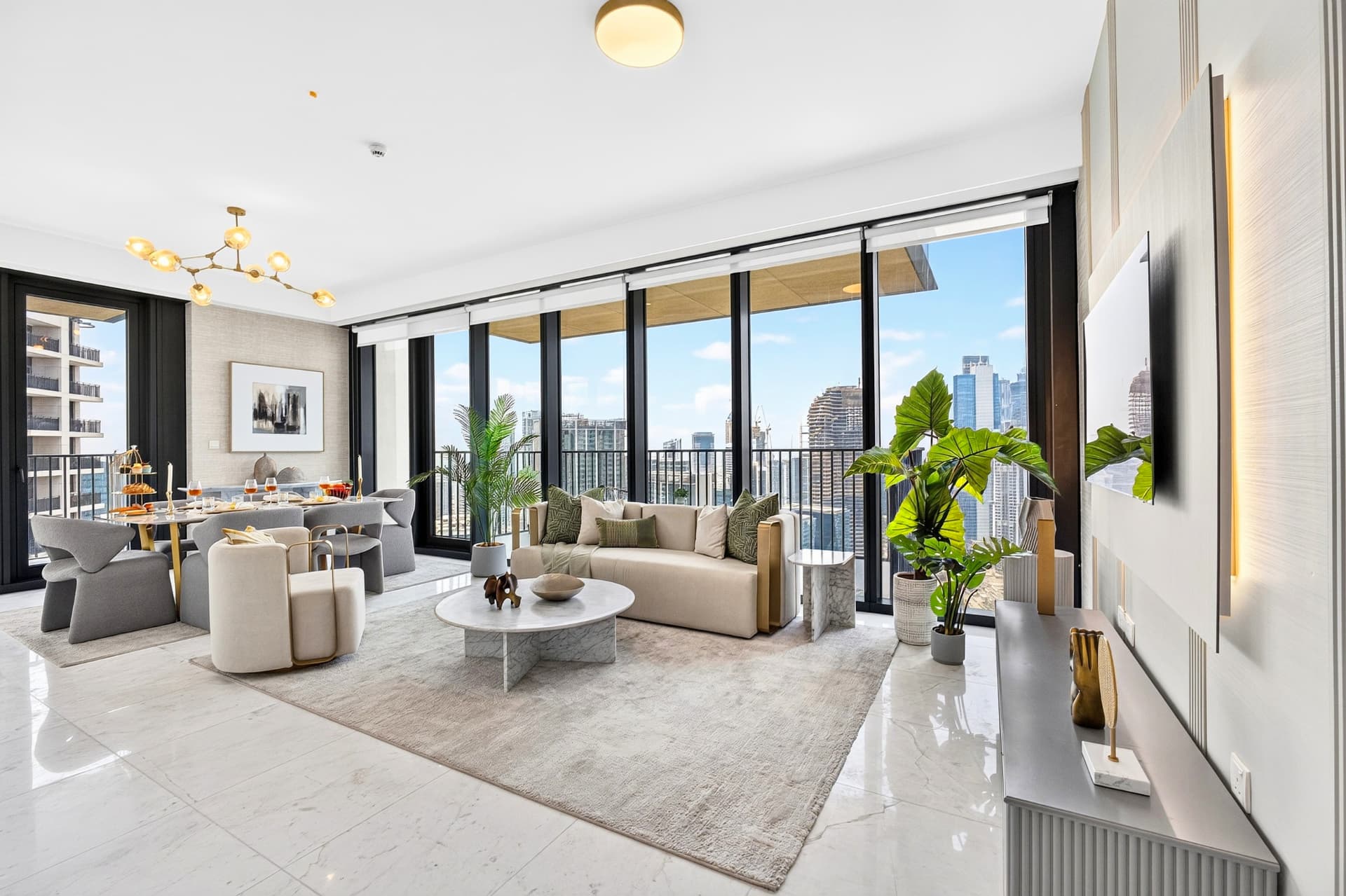Boulevard Heights living and dining area with skyline views and brass chandelier