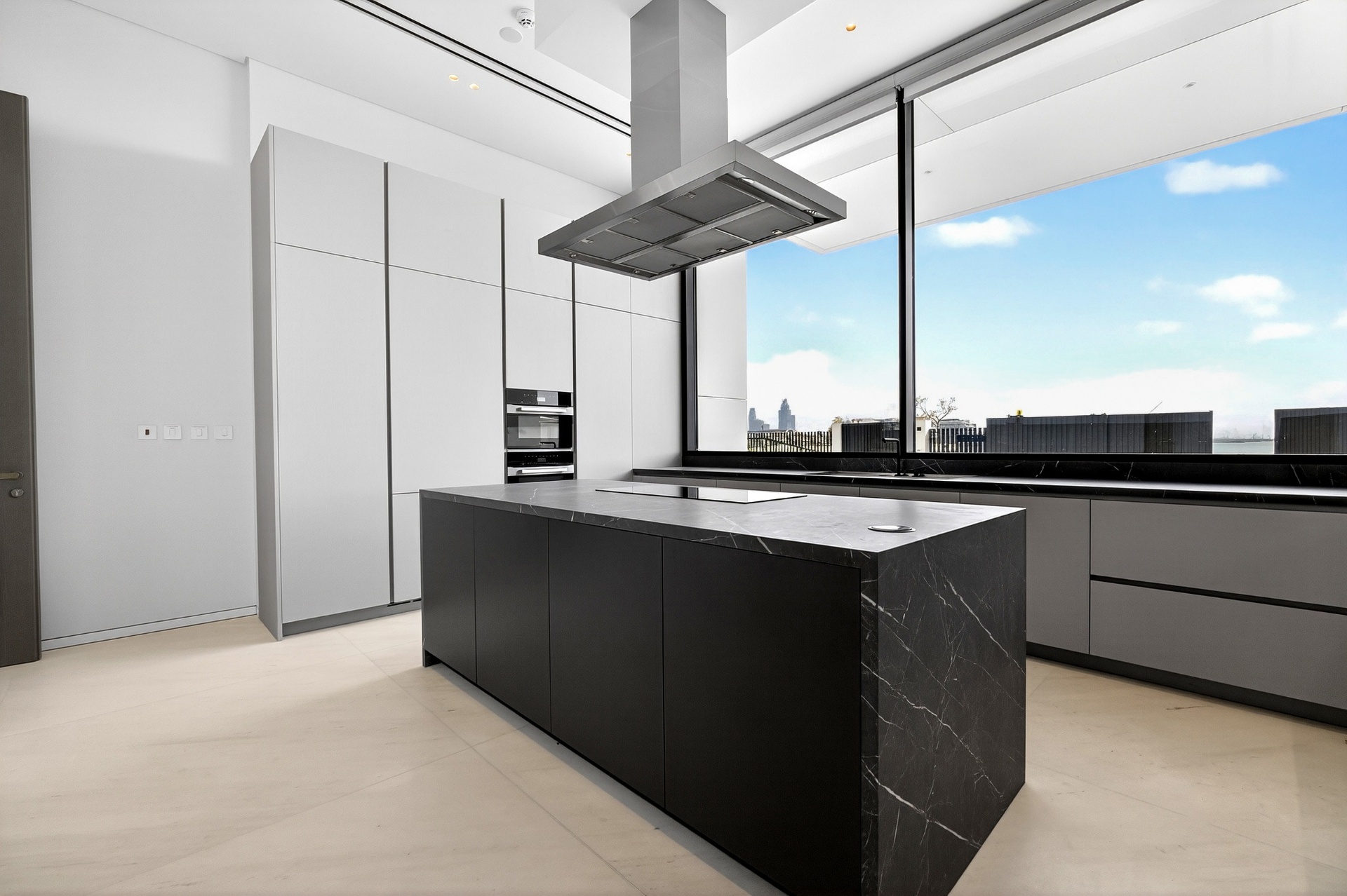Villa A9 minimalist kitchen with dark stone island and panoramic window