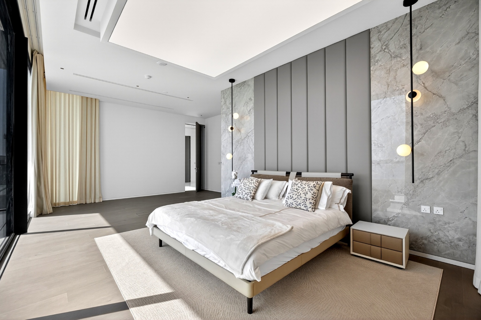 Villa A9 bedroom with marble wall panels and pendant bedside lights