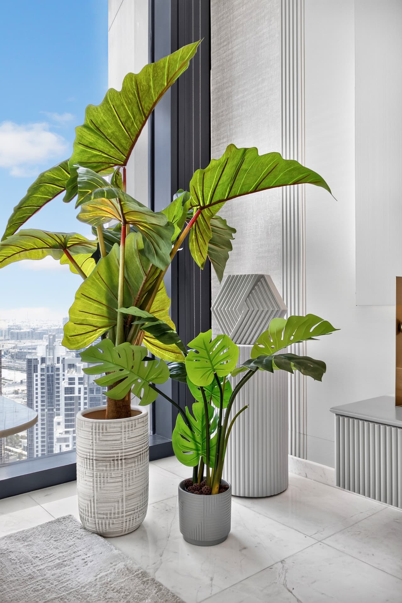 Boulevard Heights window corner with sculptural planters and Dubai skyline