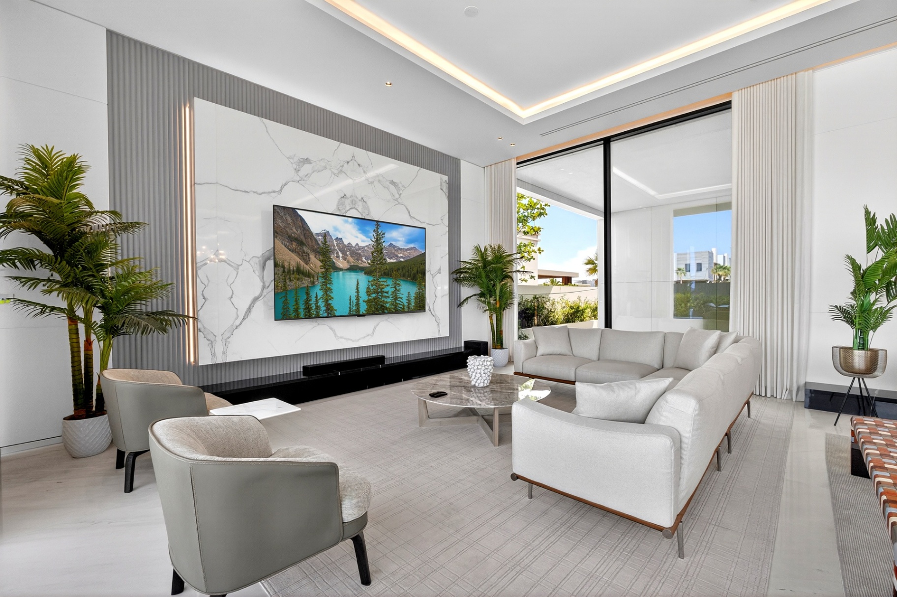 Villa A9 wide living room composition with curved sofas and dining area beyond